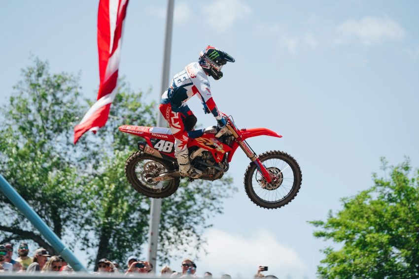 A person on a dirt bike doing a trick